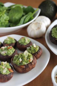 Spinach Avocado Stuffed Mushrooms! 1. Bake 8-10 baby portobello mushrooms (lightly drizzled with olive oil), cap up without stems in a preheated 450 degree oven for 7 minutes. 2. Blend the filling: 1 1/2 c spinach, 1 garlic clove, 1 medium avocado, 1/4 c walnuts, 1 tbsp each of nutritional yeast and lemon juice. Add salt for taste 3. Spoon into mushrooms and serve or stick it into the oven again at 450 degrees for 3-5 minutes 4. Add salt and almond garnishes for taste!