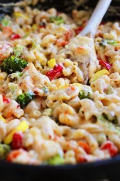 Roasted Vegetable Mac 'n Cheese Spicy Roasted Vegetable Macaroni and Cheese Makes 6 servings Printable Recipe Ingredients 1 cup broccoli florets, chopped into small chunks 1/2 red pepper, diced 1 yellow squash, quartered and diced 10 baby carrots, sliced thinly 2 cups whole wheat pasta (elbow macaroni, rotini, penne, etc.) 1/4 cup olive oil 1 garlic clove, minced 3 Tbsp. all-purpose flour 1 1/2 cups milk 2 cups (8 oz.) Sargento® Shredded Sharp Cheddar Cheese 1/2 tsp. crushed red pepper flakes 1/2 tsp. cayenne pepper Salt and pepper, to taste 2 Tbsp. panko breadcrumbs Directions Preheat oven to 400 degrees F. Set a medium pot of salted water to boil. Prepare a large baking sheet by lining with aluminum foil and coating with a little olive oil or nonstick cooking spray. Toss broccoli, red pepper, squash and carrots onto the baking sheet. Bake for 20 minutes, or until vegetables have softened. Remove from oven and set aside. Once water is boiling, lower heat slightly and add pasta,cooking according to package instructions. Drain and set aside. Meanwhile, heat oil in a large skillet over medium heat. Once hot, add garlic and cook 30 seconds. Whisk in flour and cook 1 minute. Gradually whisk in milk, stirring constantly until mixture is slightly thickened. Remove from heat. Stir in cheddar cheese until well distributed and melted. Add red pepper flakes, cayenne pepper, salt and pepper. Add macaroni and vegetables. Place mixture in a large casserole dish and sprinkle with panko breadcrumbs. Place under the broiler in your oven (500 degrees) for 3-4 minutes, or until the top is golden